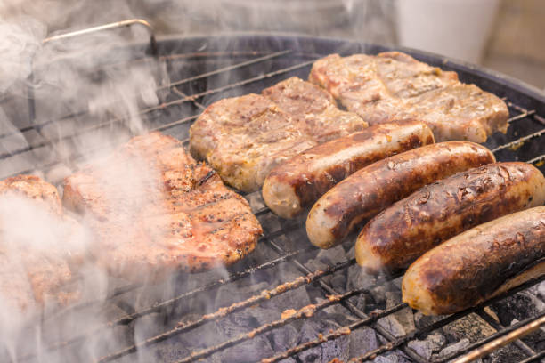 istock Smoldering charcoal grill with steaks and sausages 1014808328