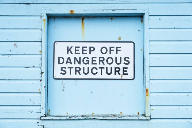 istock Keep off dangerous structure sign on duck egg coloured wooden wall 1014814266