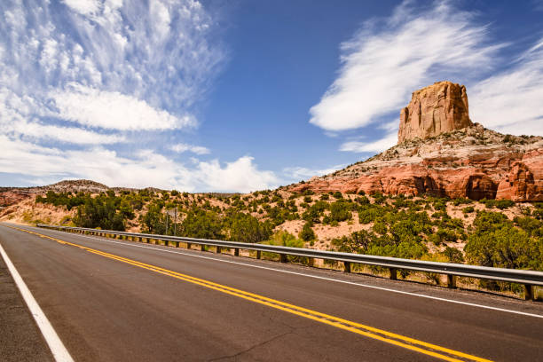 Majestic red-brown landscapes are intersected by narrow multi-colored canyons. The smooth asphalt highway runs between the picturesque ridges of the San Rafael Reef