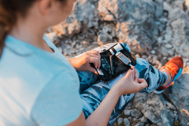 Woman with diabetes checking her blood glucose using her glucose meter Woman with diabetes checking her blood glucose using her glucose meter travel diabetes stock pictures, royalty-free photos & images