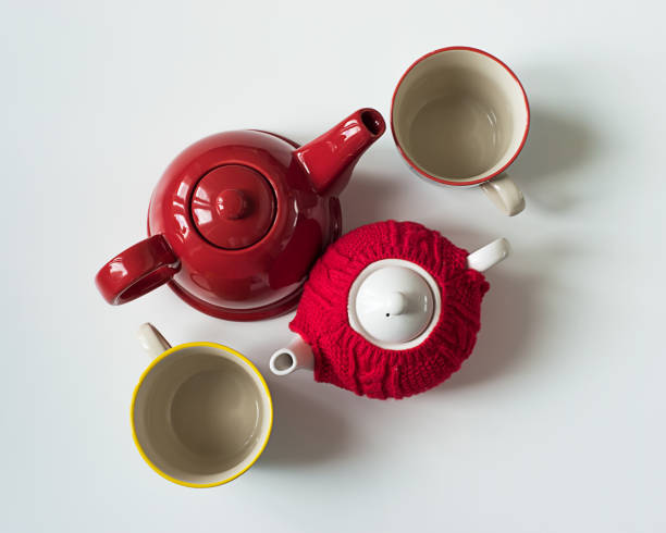 istock Red teapots and teacups on white table seen from above 1014818658