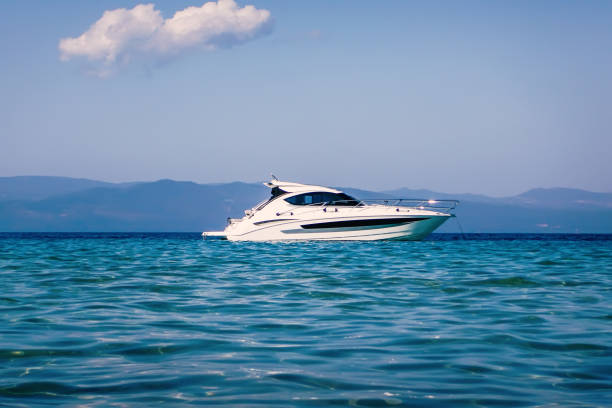 istock Motor boat floating on clear turquoise water 1014819492