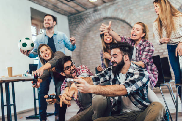istock Coworkers playing video games in office 1014821878