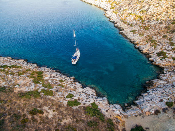 istock Sailboat anchored in peaceful bay 1014822904