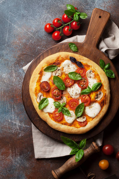 istock Italian pizza with tomatoes, mozzarella and basil 1014823072