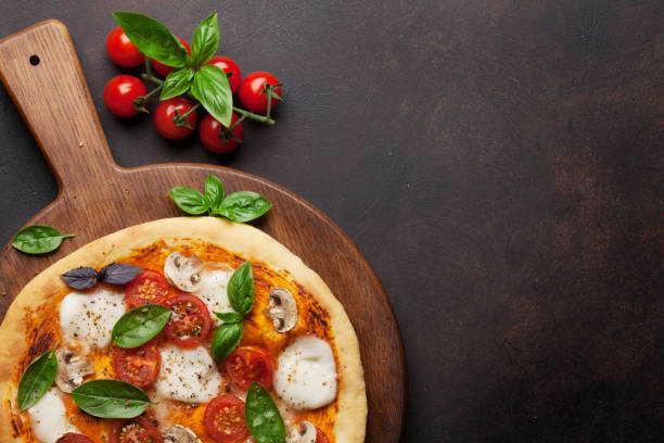 istock Italian pizza with tomatoes, mozzarella and basil 1014823336