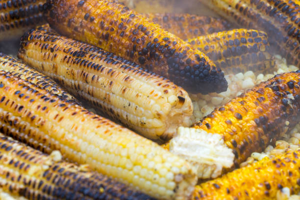 Grilled corn ready for sale by a street vendor in Guanajuato, Mexico. The grilled corn is also called elote
