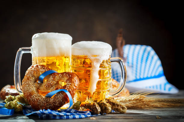 Beer mugs and pretzels on a wooden table. Beer Fest. Beer festival. Beer mugs and pretzels on a wooden table. Beer Fest. Beer festival. Selective focus. oktoberfest food stock pictures, royalty-free photos & images