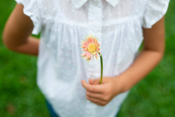 istock Girl with flower 1014834462
