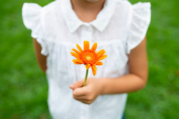istock Girl with flower 1014834476