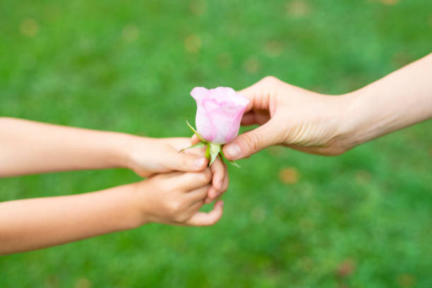 istock Parent and child handing flower 1014834606