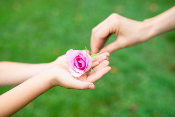 istock Parent and child handing flower 1014834654