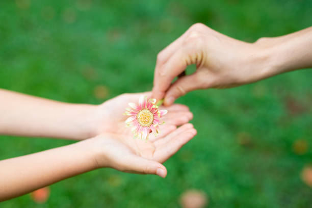 istock Parent and child handing flower 1014834672