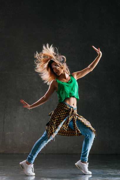 istock Young beautiful female dancer is posing in the studio 1014843068