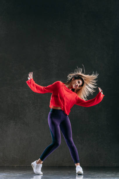 istock Young beautiful female dancer is posing in the studio 1014843412