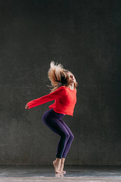 istock Young beautiful female dancer is posing in the studio 1014843608