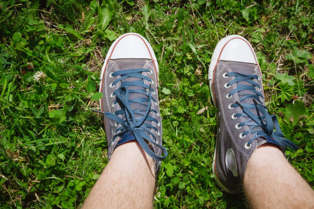 istock Denim sneakers on green grass in summer 1014843766