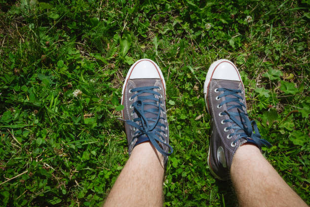 istock Denim sneakers on green grass in summer 1014843776