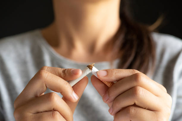 world no tobacco day, may 31. stop smoking. close up woman hand breaking, crushing or destroying cigarettes on black background. - quitting imagens e fotografias de stock