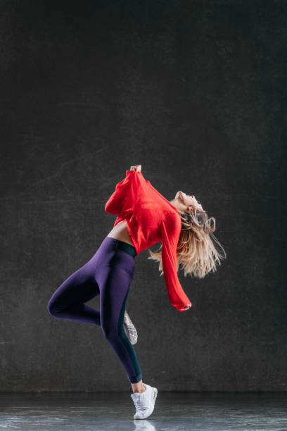 istock Young beautiful female dancer is posing in the studio 1014843898
