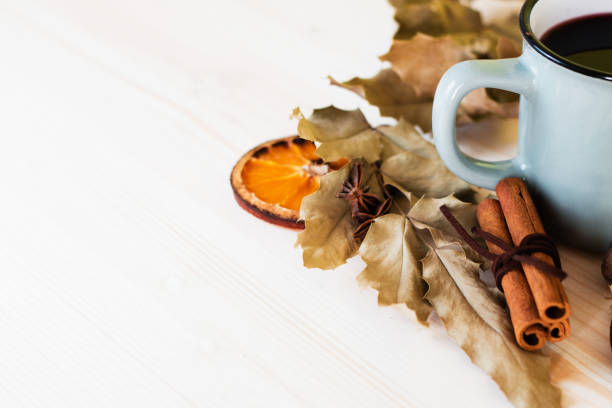 istock Autumn, fall leaves, hot steaming cup of glint wine 1014843948