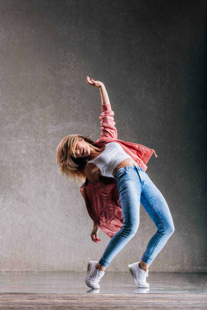 istock Young beautiful female dancer is posing in the studio 1014846810