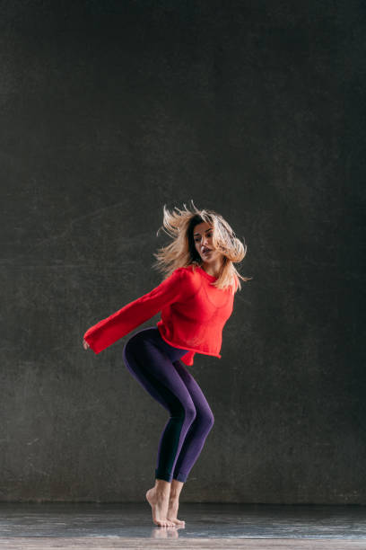 istock Young beautiful female dancer is posing in the studio 1014848284