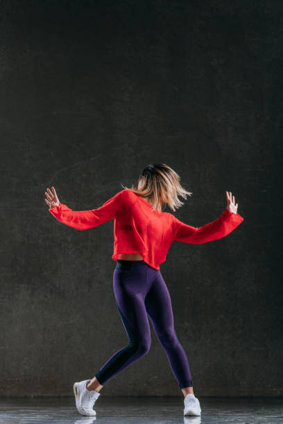 istock Young beautiful female dancer is posing in the studio 1014848448