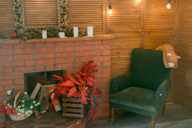 The green velvet chair in front of the fireplace