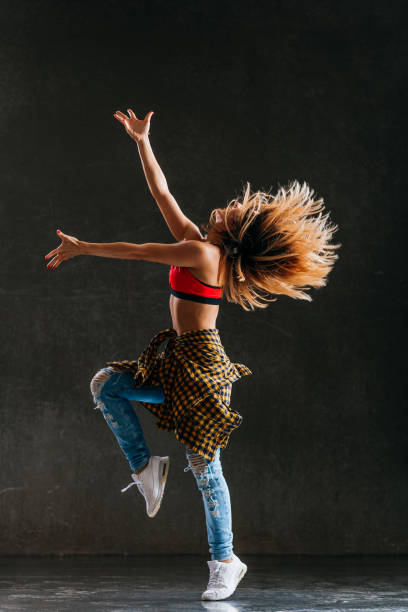istock Young beautiful female dancer is posing in the studio 1014850804