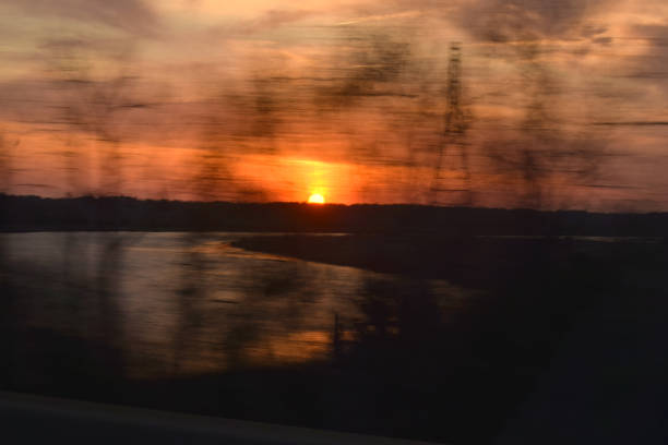 istock Dramatic Sunset Over River in Industrial Area 1014850814