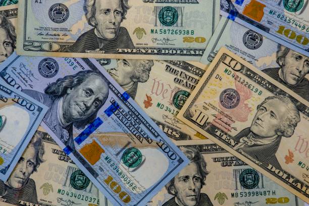 istock US Dollars banknote wallpaper background whole screen bundle of dollars banknotes 1014850956