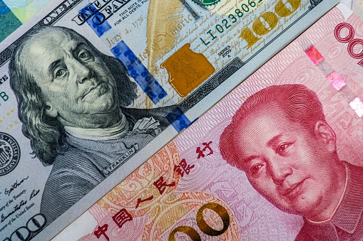 Face to face of US dollar banknote and China Yuan banknote for 2 biggest economic in the world which now United states of America and China have war trade.Both countries conflict increase tariff tax.