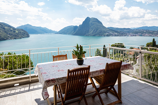 Large terrace overlooking the lake of Lugano on a summer day