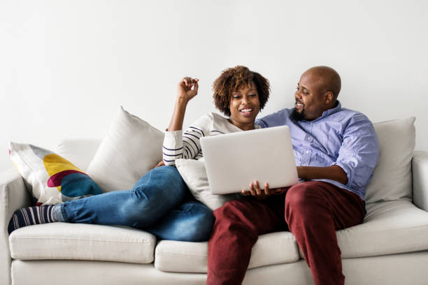 istock Couple using laptop together on the couch 1014857738