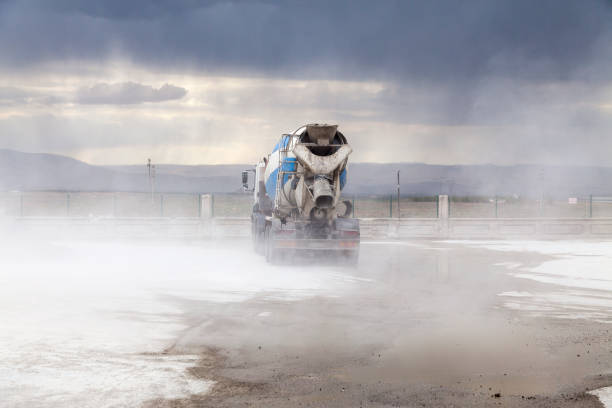istock Cement plant and cement mixer trucks 1014861428