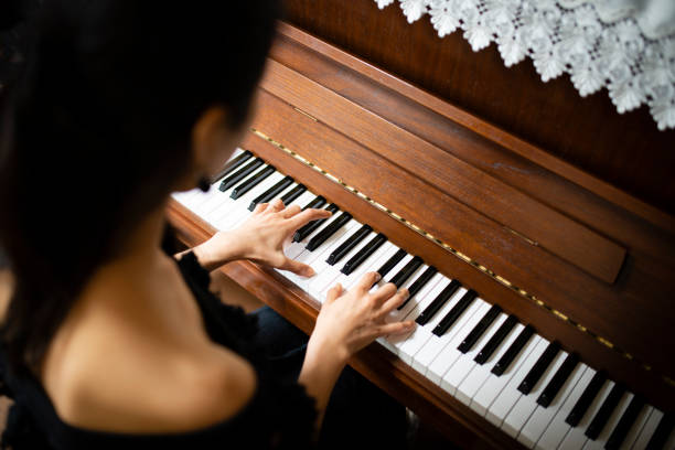 istock Woman playing the piano 1014876670