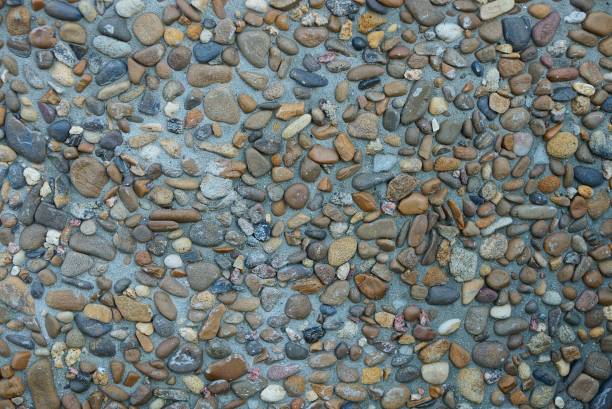 istock small gray and brown stones in the foundation in the wall 1014880230