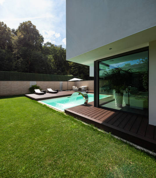 istock Exterior modern white villa with pool and garden 1014883688