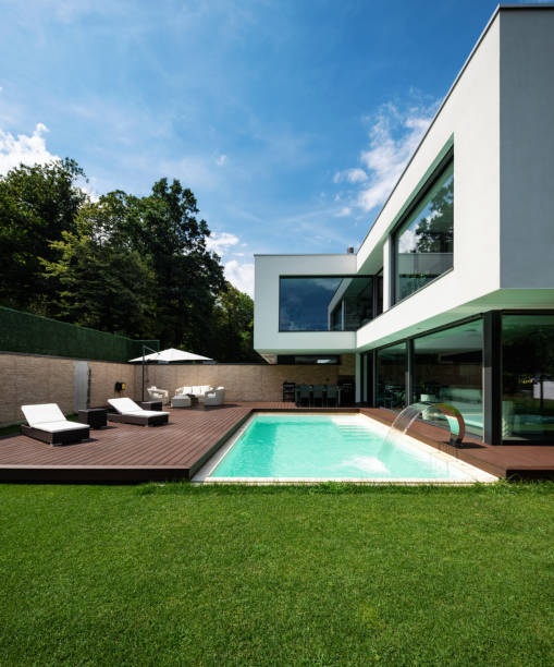 istock Exterior modern white villa with pool and garden 1014883718