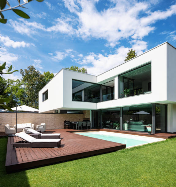 istock Exterior modern white villa with pool and garden 1014883746