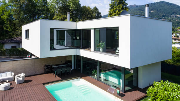 istock Exterior modern white villa with pool and garden 1014883830