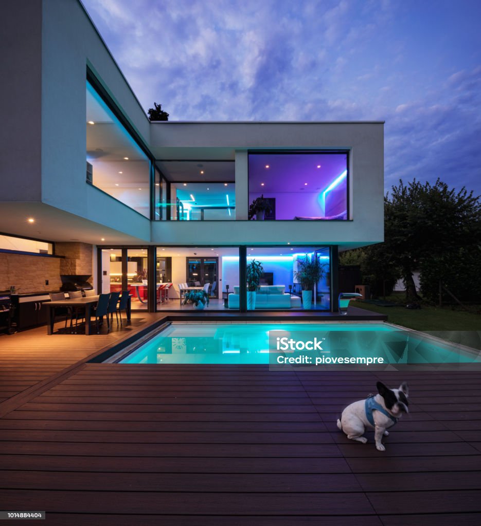 Modern villa with colored led lights at night Modern villa with colored led lights at night. Nobody inside House Stock Photo