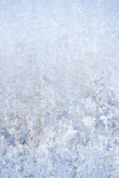 istock Winter frosty patterns on the frozen ice window 1014887070