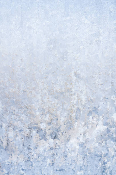 istock Winter frosty patterns on the frozen ice window 1014887080