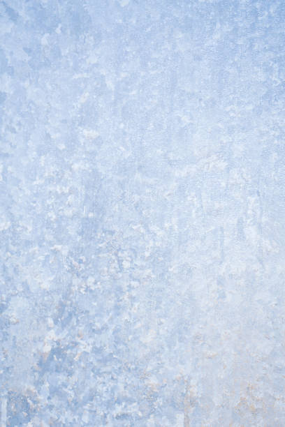 istock Winter frosty patterns on the frozen ice window 1014887180