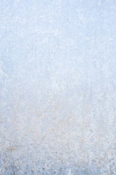 istock Winter frosty patterns on the frozen ice window 1014887188