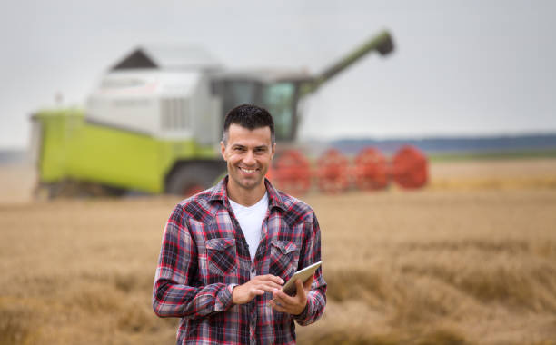 istock Farmer with tablet on field during harvest 1014887486