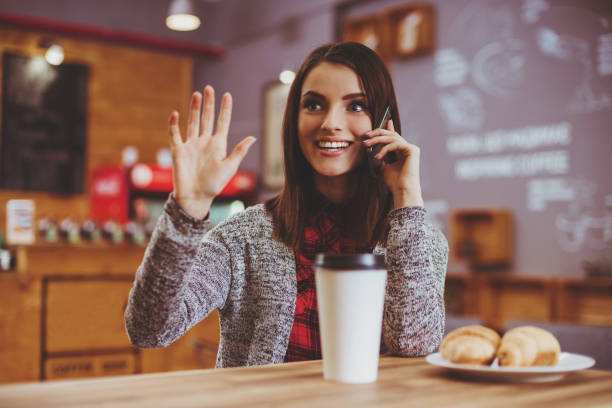 istock Young Woman with Mobile in Cafe. 1014888074