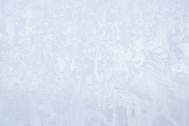 istock Winter frosty patterns on the frozen ice window 1014888646